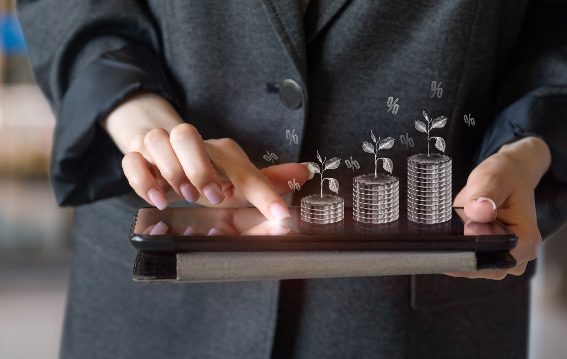 Businesswoman with tablet and growing investments.